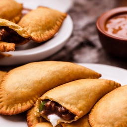 A photograph of a plate of Chilean Empanadas, generated by AI