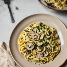 A photograph of a plate of Creamy Garlic Mushroom Pasta, generated by AI