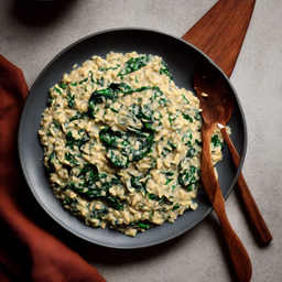 A photograph of a plate of Creamy Mushroom And Spinach Risotto, generated by AI