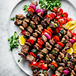 A photograph of a plate of Greek Lamb Kebabs, generated by AI