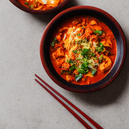 A photograph of a plate of Kimchi Jjigae, generated by AI