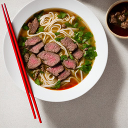 A photograph of a plate of Vietnamese Beef Noodle Soup, generated by AI